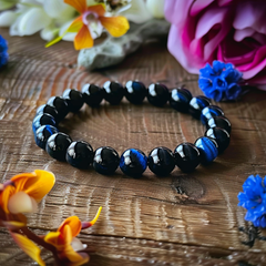 Blue Tiger Eye Bead Bracelet on Wooden Table with Flowers